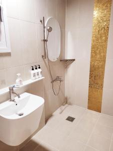 a bathroom with a sink and a shower with a mirror at Vong Stay 봉스테이 in Chilgok +55 photos