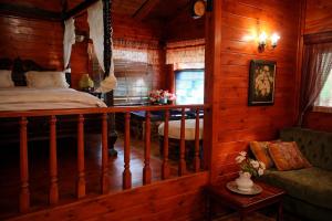 a bedroom with a bed in a log cabin at Suite in nature in Menaẖemya +22 photos