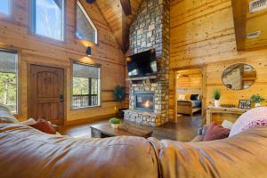 a living room with a couch and a fireplace at Wide Glide Lodge - In-home Movie Room, Hot Tub and Large 1-acre property with Playset in Broken Bow