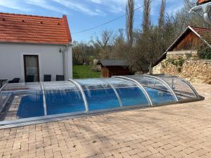 a swimming pool with a glass bridge over it at Bleu Fontaine in Kékkút