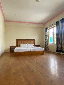 a bedroom with a bed with a wooden bed frame at Summer Villa in Leh +10 photos