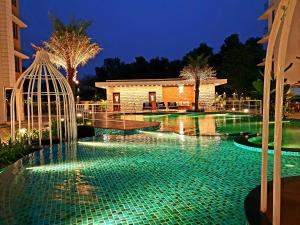 a swimming pool at night with a gazebo at Panthashala Santiniketan in Srī Niketan