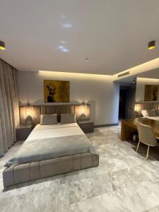 a bedroom with a large bed and a desk at The Pilgrim Ephesus Hotel in Selçuk