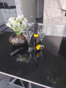 a bottle of wine sitting on a table with glasses at New Haven Atherton Greater Manchester in Atherton