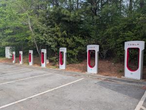 a row of red and white toilets in a parking lot at Garden Inn Adairsville in Adairsville