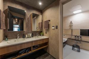 a bathroom with two sinks and a toilet at Betsuan Private Villa in Kuwana +36 photos