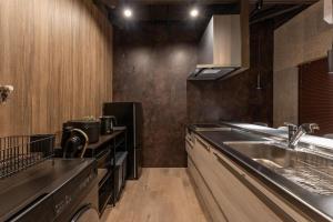 a kitchen with a sink and a counter top at Betsuan Private Villa in Kuwana