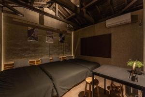 a bedroom with a bed and a tv and a table at Betsuan Private Villa in Kuwana