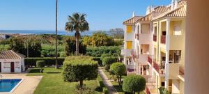 a view of a house with a garden and a swimming pool at Dunas de vilamoura in Quarteira