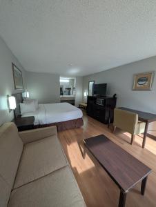 a hotel room with a bed and a desk at Garden Inn Adairsville in Adairsville