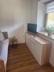 a living room with a desk with a television on it at Ute Urbaner in Irschen