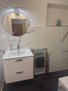 a bathroom with a white sink and a mirror at Ute Urbaner in Irschen +5 photos