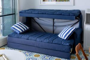 a blue bunk bed in a room with two pillows at Villetta La Conca in Conca dei Marini