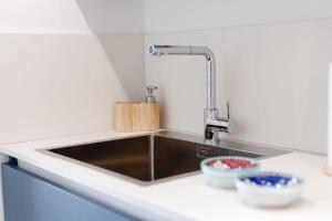 a kitchen sink with two bowls on a counter at Villetta La Conca in Conca dei Marini +24 photos