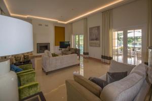 a large living room with couches and a television at Villa Buganvilia III in Aroeira