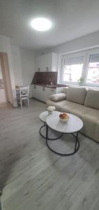 a living room with a couch and a table at Apartman Katić 2 in Odžak