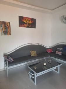 a living room with a couch and a coffee table at lasofia in Mbodiène