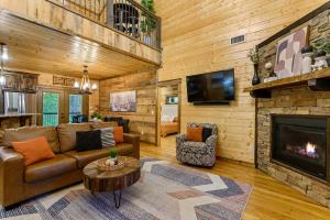 a living room with a couch and a fireplace at Low Rider Lodge - Backs to Pine Forest and ATV Trail Access from Driveway in Broken Bow