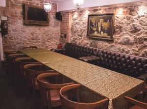 a bar with a long counter and chairs in a room at Villa Margaretha Boutique Hotell in Tartu