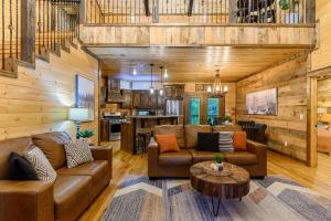 a living room with a couch and a table at Low Rider Lodge - Backs to Pine Forest and ATV Trail Access from Driveway in Broken Bow