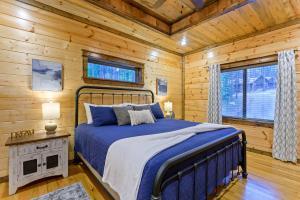 a bedroom with a bed in a log cabin at Low Rider Lodge - Backs to Pine Forest and ATV Trail Access from Driveway in Broken Bow