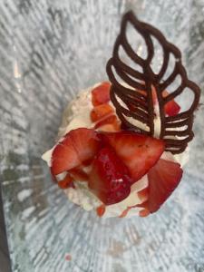 a dessert with strawberries and chocolate on a glass plate at Corte Impero Hotel & Restaurant in Affi