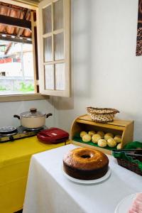 a table with a loaf of bread on a table at Vila Rica Hospedaria in Ouro Preto +2 photos
