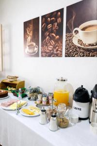 a table with breakfast foods and coffee on it at Vila Rica Hospedaria in Ouro Preto