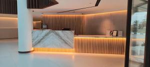 a lobby with a large marble counter in a building at Arabian Palace Hotel in Al Rahba +4 photos