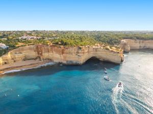 an aerial view of boats in the water under a bridge at Villa Phi Phi - com piscina privada em Vilamoura in Quarteira