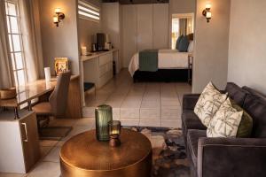 a living room with a couch and a table at Midrand Manor Guesthouse in Midrand