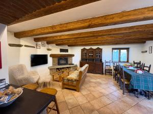 a living room with a table and a stove at Mountain Chalet Ca' dal Ghiru by Villa Bernardino Galliari in Sagliano Micca