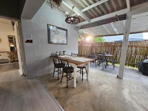 a dining room with a table and chairs on a patio at Heide Cottage in Struisbaai