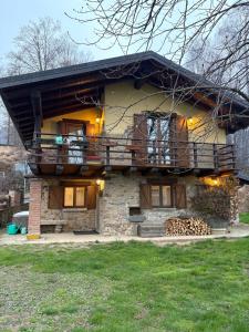 a house with a balcony on the side of it at Mountain Chalet Ca' dal Ghiru by Villa Bernardino Galliari in Sagliano Micca
