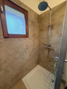 a bathroom with a shower with a window at La Maison d'Amélie à Arnac-Pompadour in Arnac-Pompadour