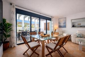 a living room with a table and chairs and a couch at Starfish Mojácar in Mojácar