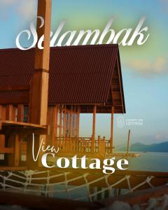 a magazine cover with a house on the water at Selambak View Cottage in Pulau Siantan