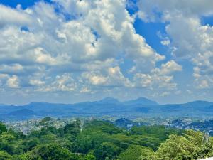 a view of a city with mountains and clouds at Bethel Rest Homestay in Kandy +26 photos
