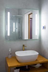 a bathroom with a sink and a mirror at Casa Joaninha in Aljustrel