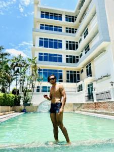 a man standing in the water in a swimming pool at Vatika Hotel Pvt Ltd in Nepālganj