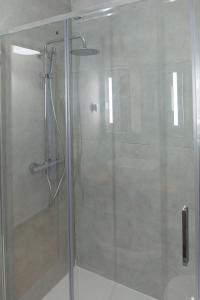 a shower with a glass door in a bathroom at Casa Joaninha in Aljustrel +18 photos