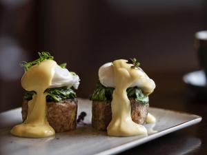 three mushrooms on top of a piece of food on a plate at Fable Terrace Downs Resort by MGallery in Windwhistle +37 photos