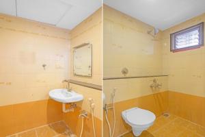 a bathroom with a toilet and a sink at MGR Residency in Pondicherry +8 photos