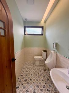a bathroom with a toilet and a sink at 八樂宿 包棟民宿 in Sanxing +36 photos