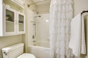 a bathroom with a white shower curtain and a toilet at Pinehurst Condo ~ 2 Miles to Downtown & Resort! in Pinehurst +22 photos