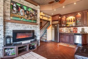 a living room with a fireplace and a tv at Pool Table, Massive Balcony, Firepit, & Spacious! in Sherrills Ford