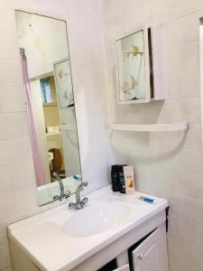 a bathroom with a sink and a mirror at Corfield in Durban +37 photos