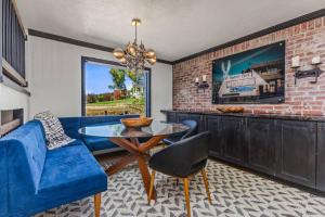 a living room with a blue couch and a glass table at The Disco Chalet in Steamboat Springs