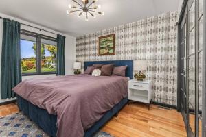 a bedroom with a large bed and a window at The Disco Chalet in Steamboat Springs