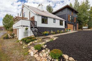 a white house with a porch and a driveway at The Disco Chalet in Steamboat Springs